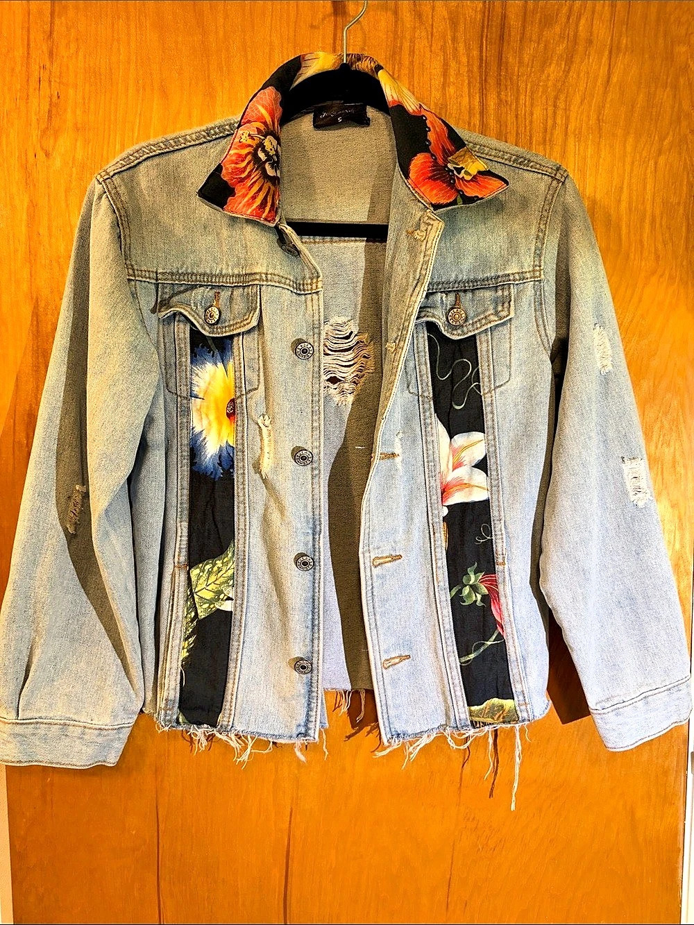 Denim Jacket Small, distressed in lt. Blue , floral details CUTE!